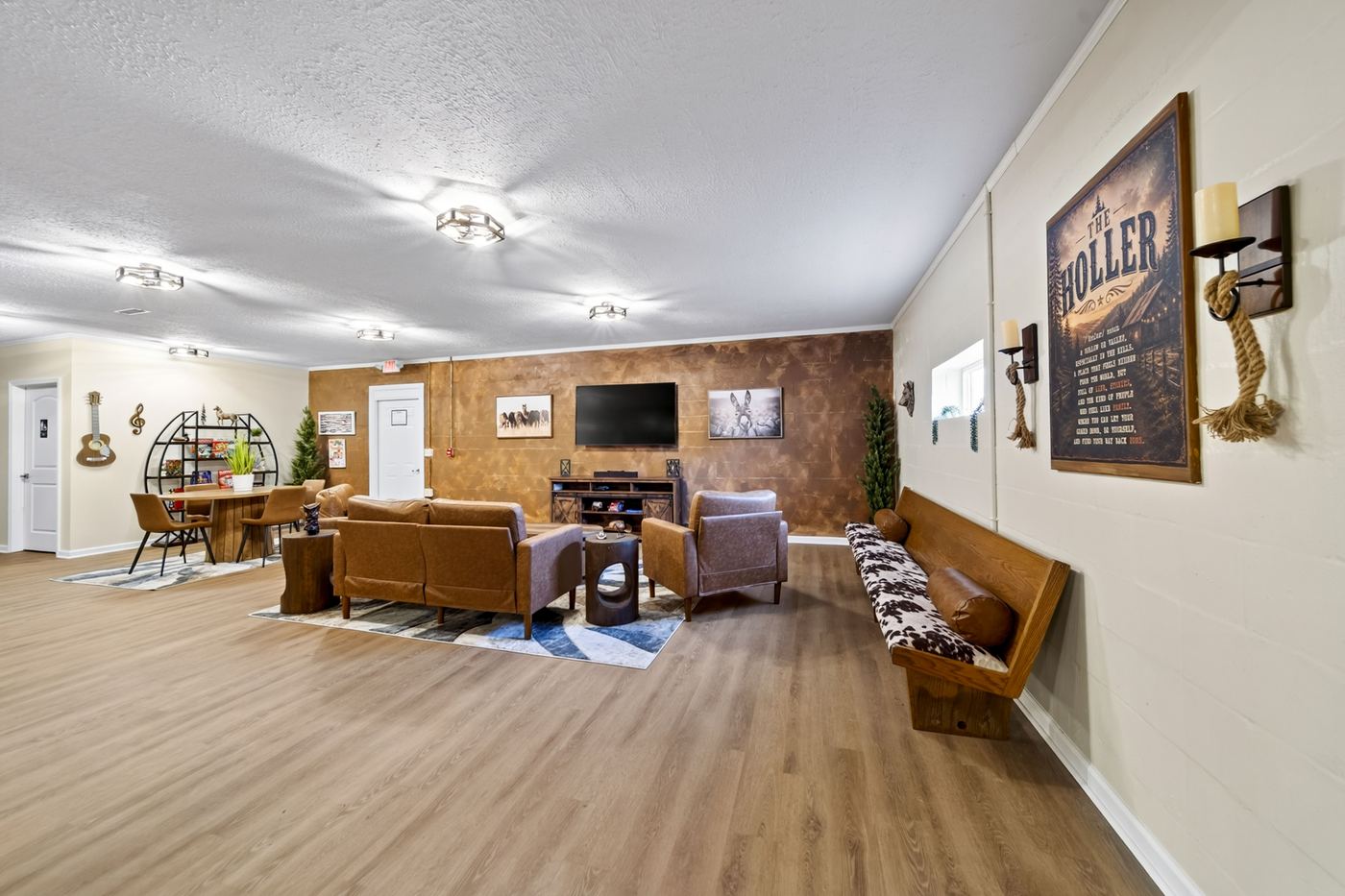 Common lounge with a tan leather sofa and armchairs around a wood coffee table