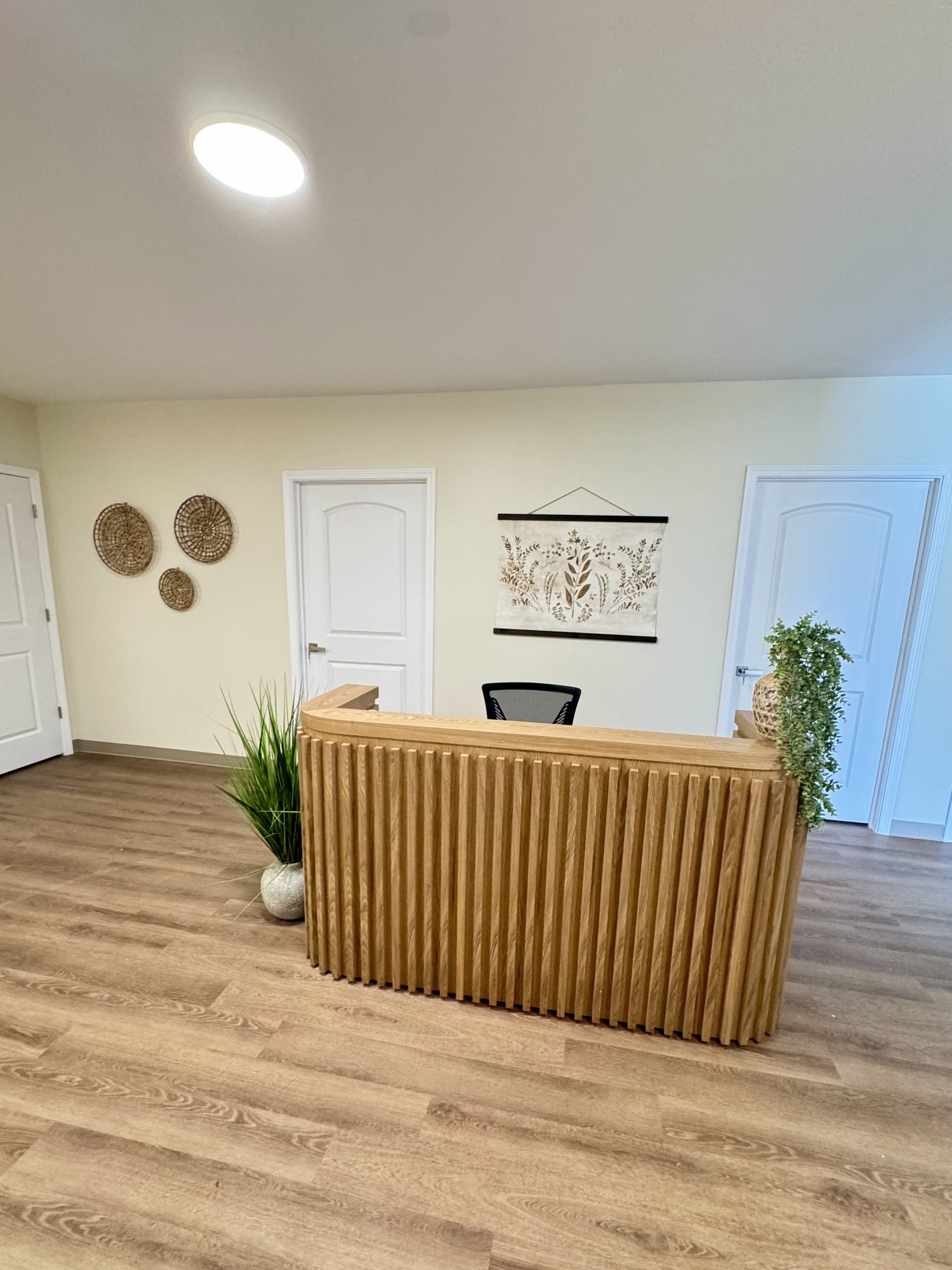 Warm, welcoming reception area at Wellness Ranch Kentucky with natural wood and greenery